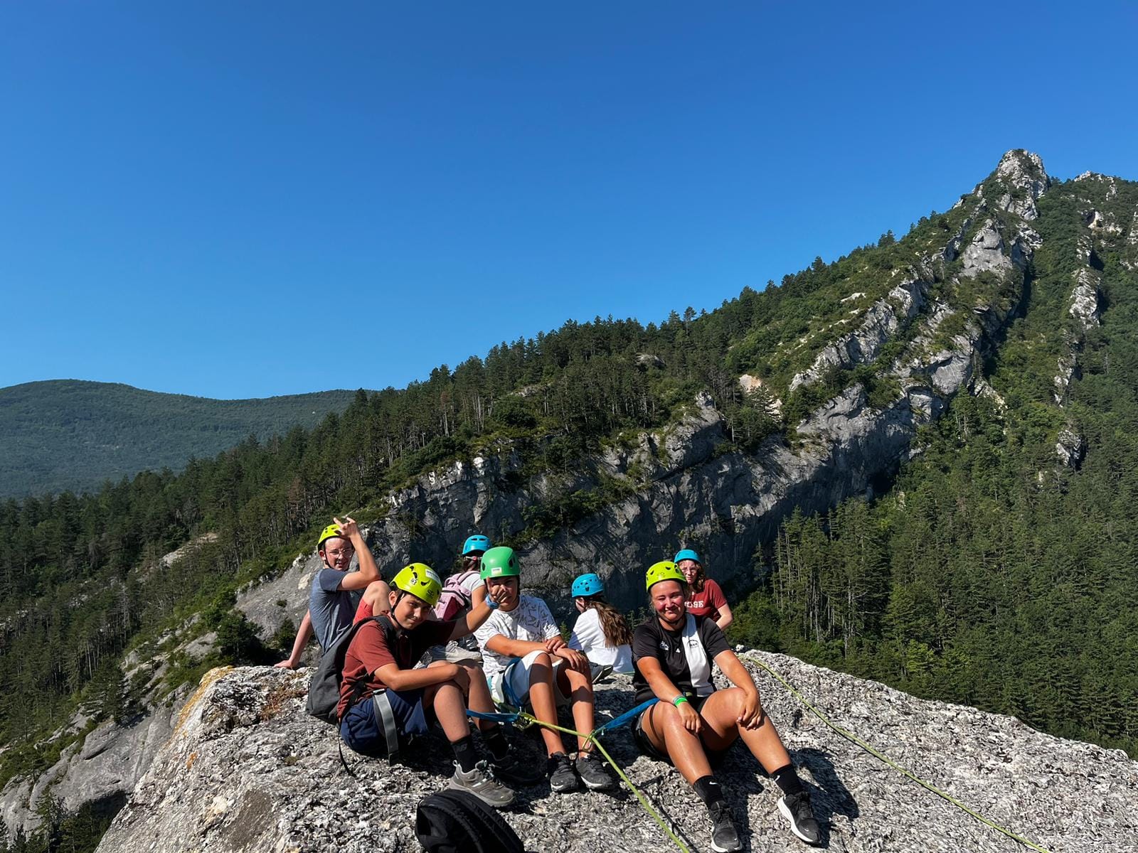 Adolescents pr&eacute;parant une randonn&eacute;e en for&ecirc;t encadr&eacute;s par un animateur